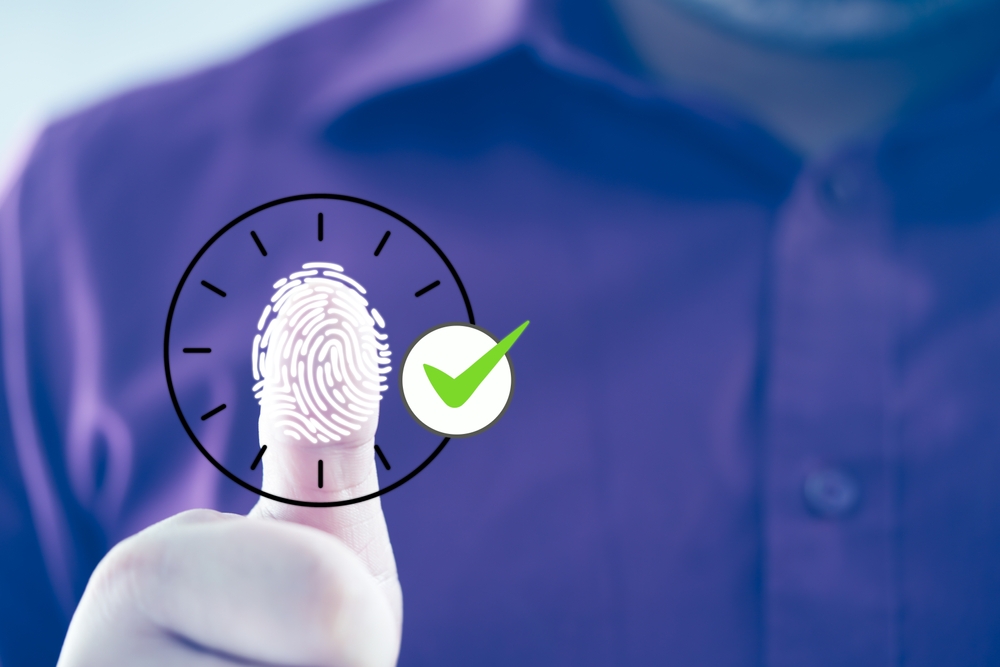 Employee scanning fingerprint record hours work time